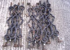 Five cast iron Victorian railings, painted black, of ornate design,