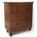 An early 20th century veneered chest of two short over two long drawers, raised on turned supports,
