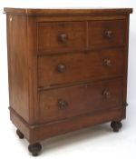 An early 20th century veneered chest of two short over two long drawers, raised on turned supports,