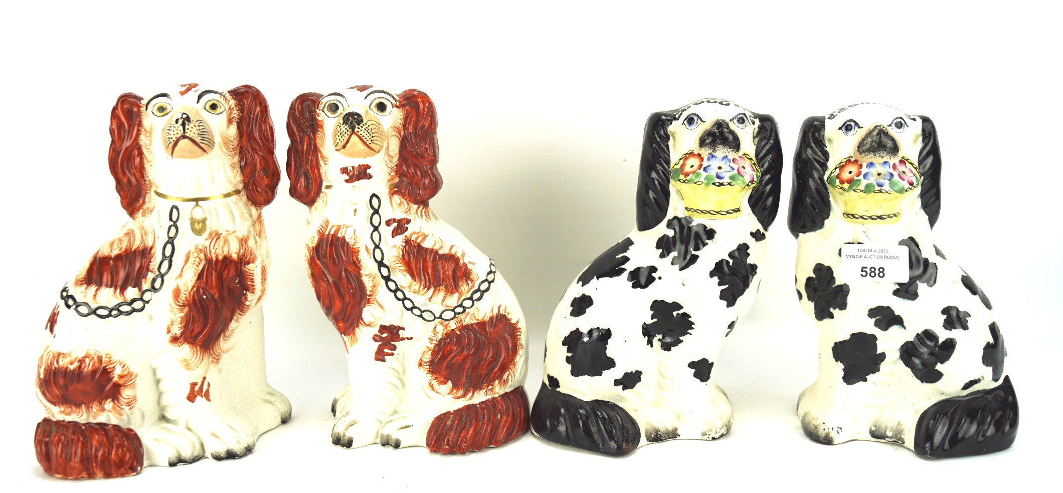 Two pairs of Staffordshire pottery spaniels, one pair in red, the other in black,