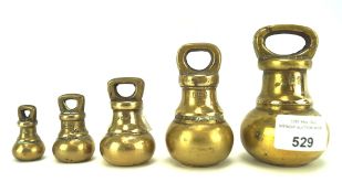 A set of five vintage brass bell weights,