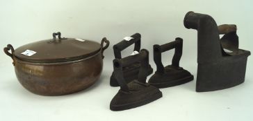 A copper bowl and four flat irons, the lidded bowl with a handle to the top and to either side,