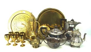 An assortment of brass and silver plate, including three teapots, two chargers,