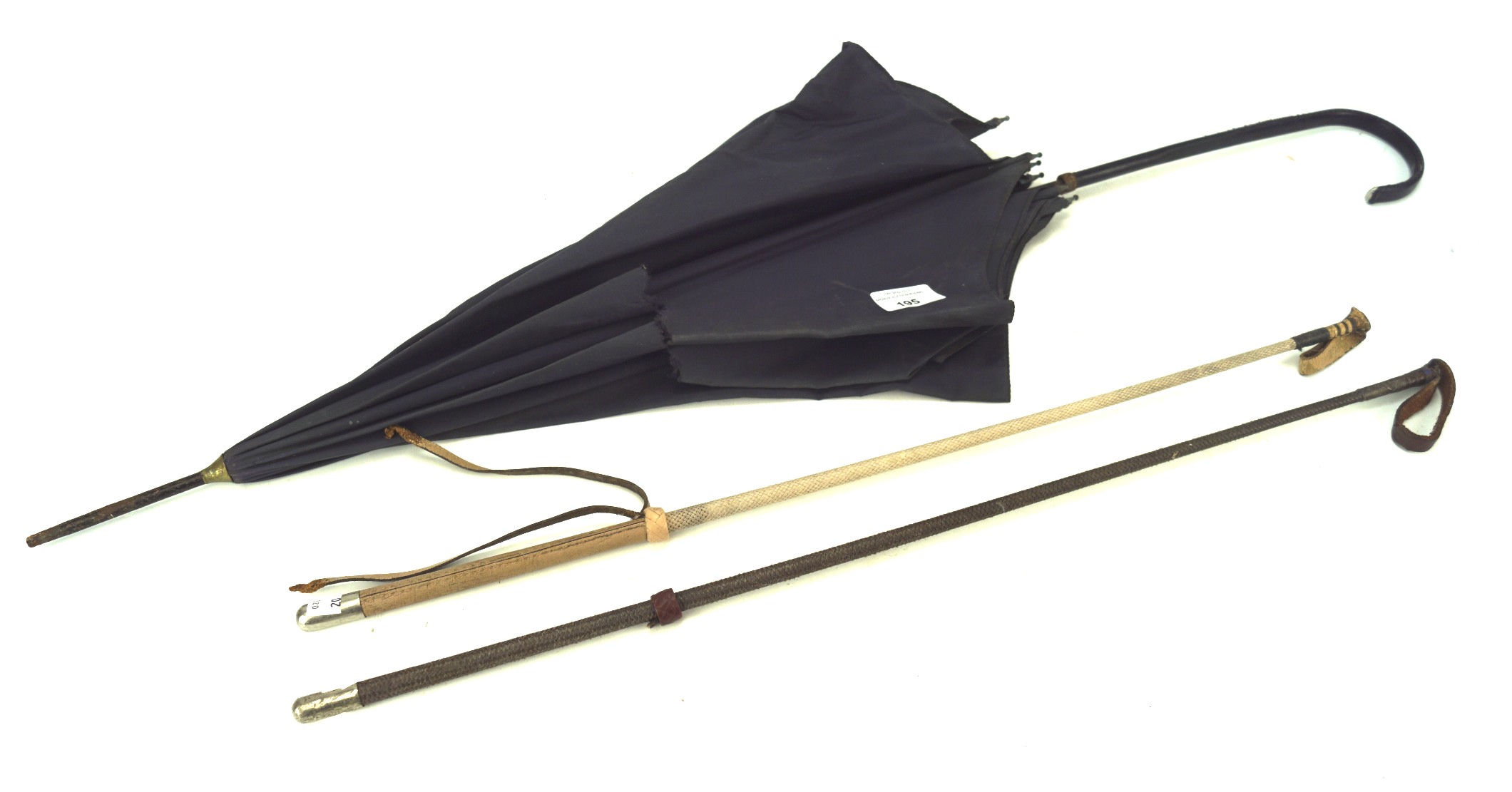 Two vintage riding crops and an umbrella,