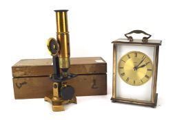 A Metamec brass carriage clock and a small microscope,