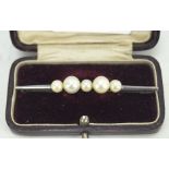 A vintage white metal pearl set bar brooch, in fitted box,