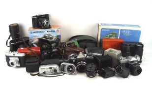 An assortment of cameras and related accessories, including a pair of Bresser 10x50 binoculars,