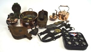 An assortment of brassware, to include oil lamps, horse brasses, chestnut roaster,