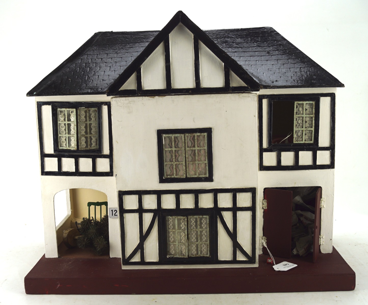 A mid-century mock Tudor style doll's house, including some fittings and contents,