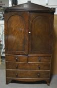 A 19th century mahogany linen press, the two cupboard doors opening to reveal five shelves,