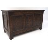 A small 19th century oak coffer, with carved floral decoration to the front,