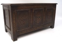 A small 19th century oak coffer, with carved floral decoration to the front,