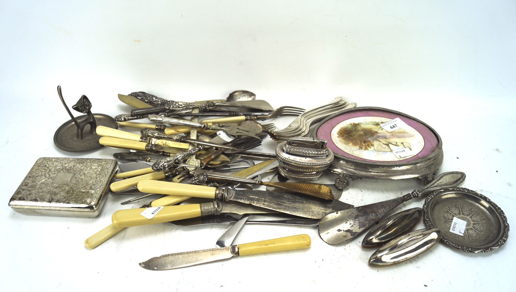 An assortment of silver plate, including a cigarette case, flatware,