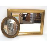 Two gilt framed wall mirrors, the larger of rectangular form, the small oval,