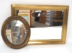 Two gilt framed wall mirrors, the larger of rectangular form, the small oval,