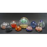 Nine glass paperweights,