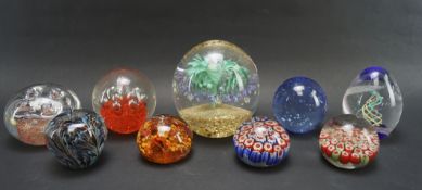 Nine glass paperweights,