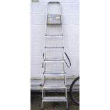 A modern folding metal ladder, with seven steps,