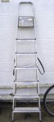 A modern folding metal ladder, with seven steps,