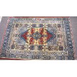 A contemporary machine made blue ground floor rug with red and beige details,
