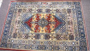 A contemporary machine made blue ground floor rug with red and beige details,