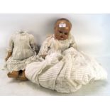 Two early 20th century dolls, one missing the head, each with composition head/bodies,