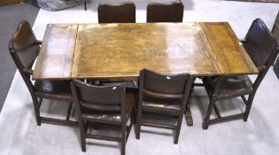 A 20th century oak extendable refectory table and six chairs, the table with a single stretcher,