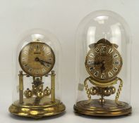 Two vintage anniversary clocks, one being by Kundo, both with glass domes,