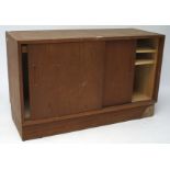 A Danish sideboard, with two sliding doors, containing adjustable shelves and trays,