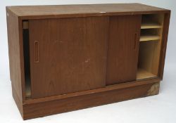 A Danish sideboard, with two sliding doors, containing adjustable shelves and trays,