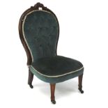 A mahogany nursing chair, with button back blue upholstery, on original castors,