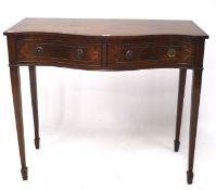 An inlaid mahogany desk, of serpentine form, with two drawers, raised on tapered supports,