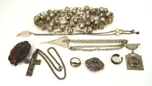 A collection of white metal jewellery, including brooches, a pendant, rings, a necklace,