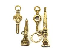 Four gilt metal pocket watch keys, two with stone set ends,