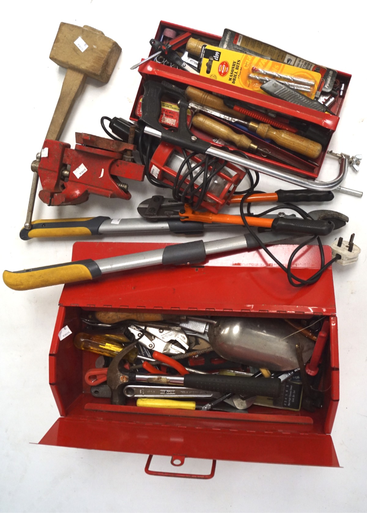 An assortment of tools, to include a workbench vice, saw and a mallet,