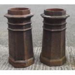 Two large terracotta chimney pots of octagonal form,