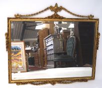 A 20th century gilt framed bevelled edge wall mirror, with urn finial to top,