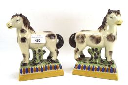 A pair of 20th century Staffordshire ceramic figures of horses,