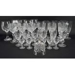 An assortment of stemmed drinking glasses, with moulded decoration, including wine glasses,