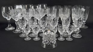 An assortment of stemmed drinking glasses, with moulded decoration, including wine glasses,