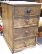 A stained pine chest of four drawers, each drawer with a turned knob, raised on plinth base,