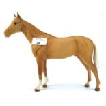 A Beswick horse, in light brown with a white mane and tail,