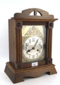 A 20th century oak cased mantel clock, the silvered dial with Arabic numerals,