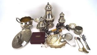 An assortment of silver plate, including shakers, a cream jug, pin dish,