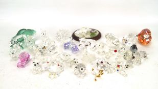 A collection of Swarovski glass and crystal animals, including hedgehogs, a squirrel, pigs,