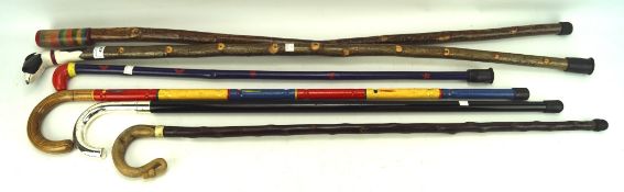 Six 20th century wooden walking sticks, of assorted sizes and designs,