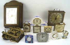 An assortment of small desk clocks and similar wares, including brass, ceramic,