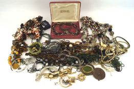 An assortment of costume jewellery, including a hardstone necklace, beads, a bangle, earrings,