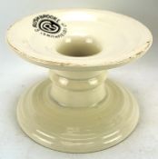 A ceramic 'Harris Stand' by G Rushbrooke Smithfield Ltd, on a circular base with white glaze, H11.