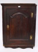 A 19th century oak corner cupboad, the single door opening to reveal three shelves,